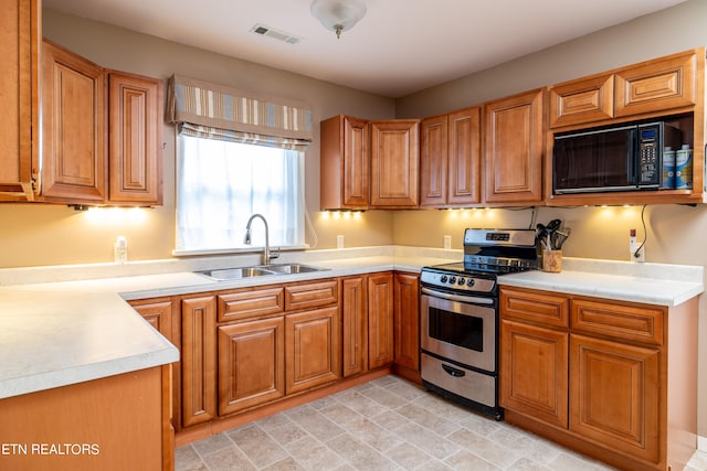 kitchen featuring stainless steel range oven and sink