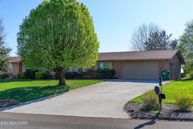 view of front facade with an attached garage, brick siding, a front yard, and driveway