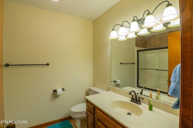 full bathroom featuring tile patterned flooring, vanity, toilet, baseboards, and an enclosed shower