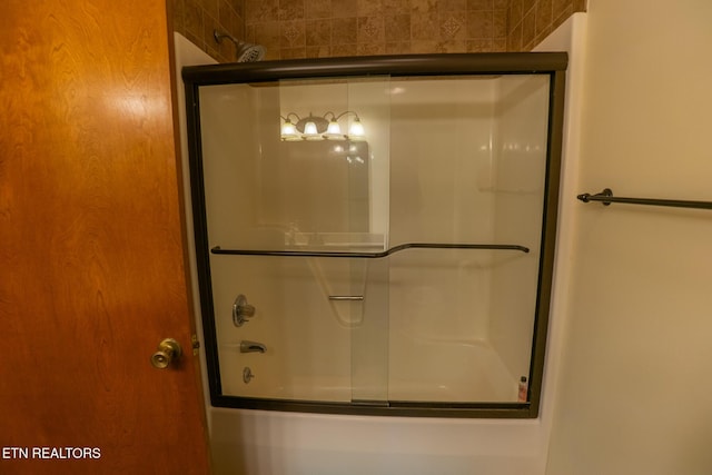 full bathroom featuring bath / shower combo with glass door