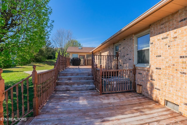 deck with a grill and visible vents