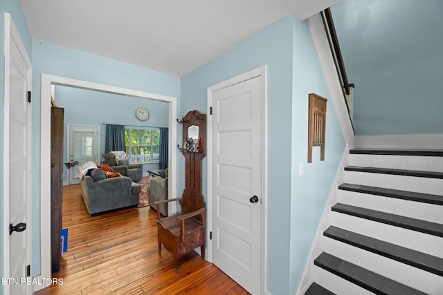 staircase with hardwood / wood-style flooring