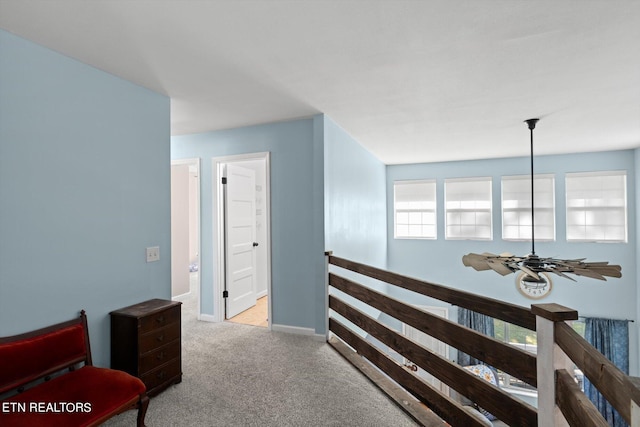 hallway featuring light colored carpet