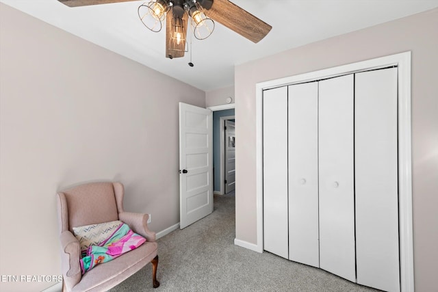 living area with light colored carpet and ceiling fan