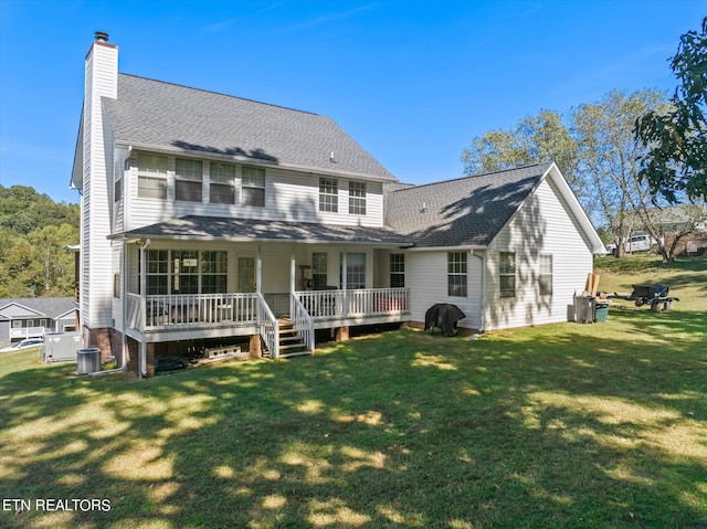 rear view of house with a lawn