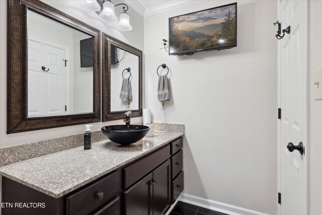 bathroom with vanity, ornamental molding, and tile patterned floors