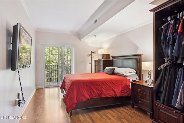 bedroom featuring ornamental molding, hardwood / wood-style floors, and access to outside