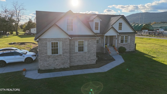 view of front of property with a front lawn and a mountain view