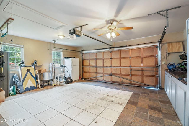 garage with a garage door opener, ceiling fan, and white refrigerator