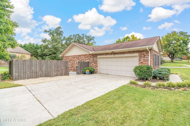 view of front of house with a front yard and a garage