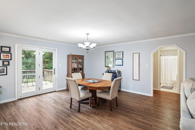 dining room featuring ornamental molding, dark hardwood / wood-style floors, and an inviting chandelier