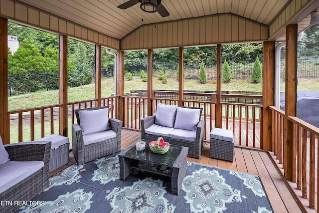 sunroom / solarium with lofted ceiling, ceiling fan, and wooden ceiling