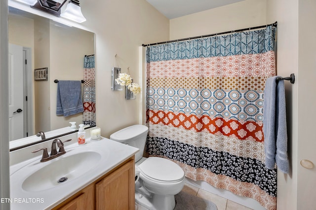 bathroom featuring vanity, toilet, walk in shower, and tile patterned flooring