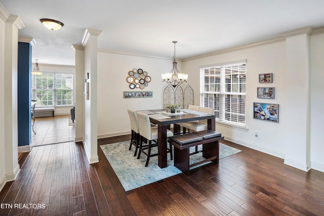 dining space with crown molding, dark hardwood / wood-style floors, and an inviting chandelier