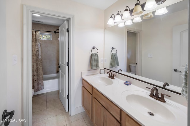 full bathroom with vanity, toilet, tile patterned floors, and shower / tub combo