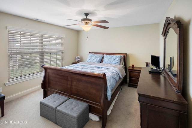 bedroom with ceiling fan and light colored carpet