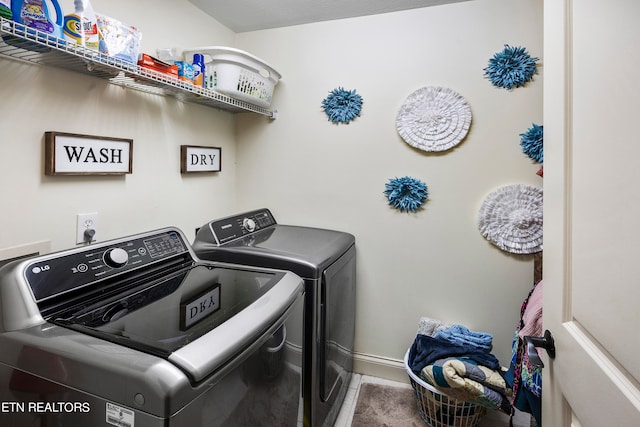 clothes washing area featuring washer and dryer and tile patterned flooring