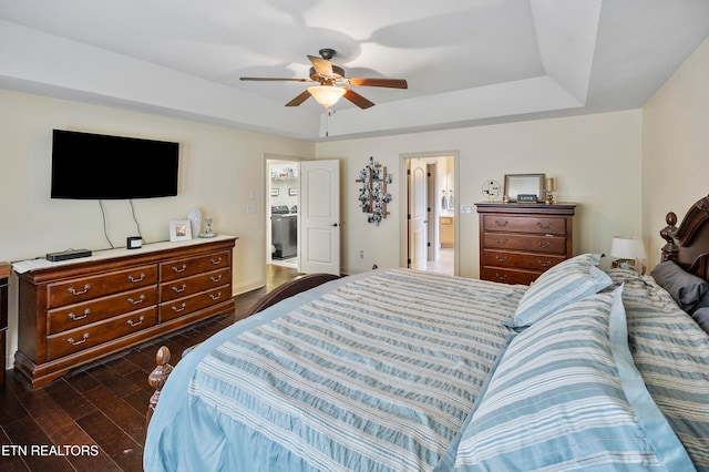 bedroom with ensuite bath, washer / clothes dryer, dark hardwood / wood-style floors, and ceiling fan