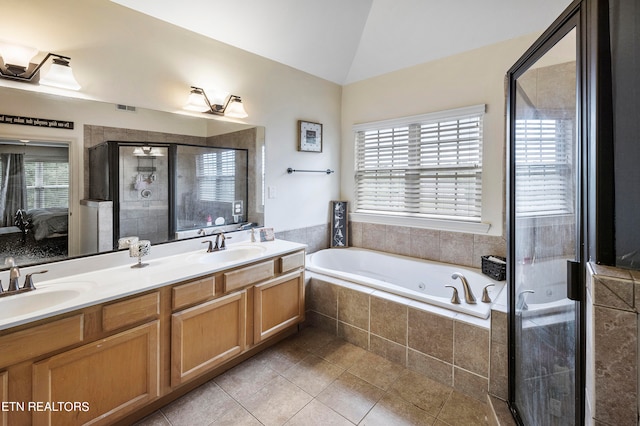 bathroom with vanity, plus walk in shower, plenty of natural light, and vaulted ceiling