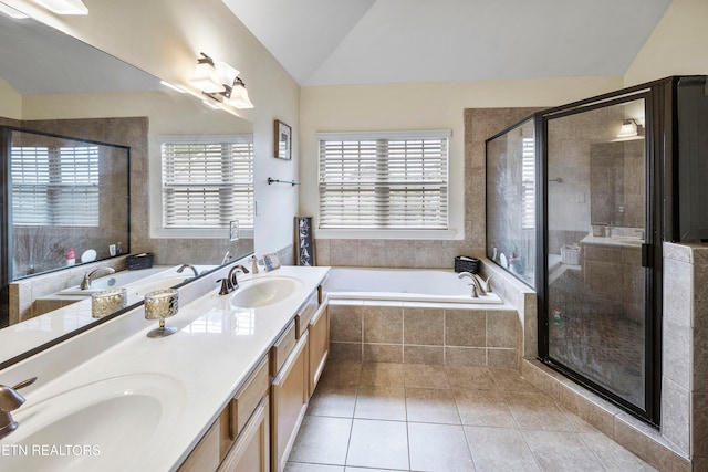 bathroom featuring vanity, tile patterned flooring, independent shower and bath, and vaulted ceiling