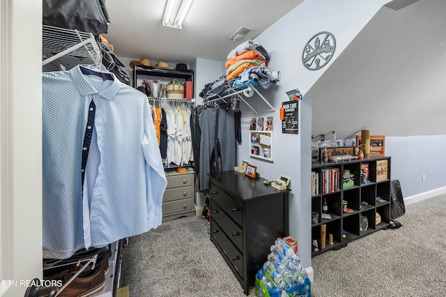 walk in closet featuring carpet