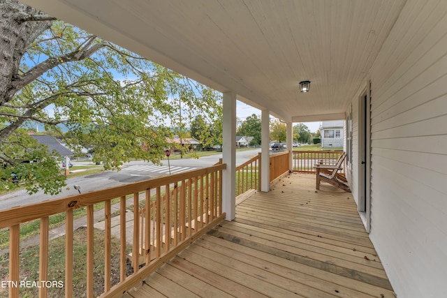 wooden terrace with a porch