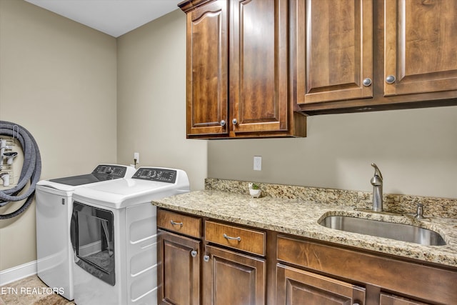 laundry area with cabinets, sink, and washing machine and clothes dryer