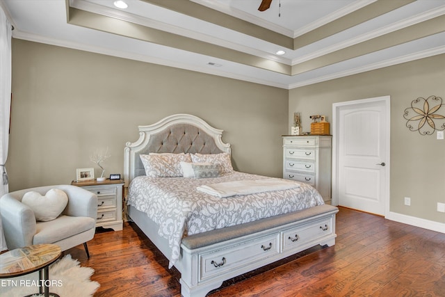 bedroom with ornamental molding, ceiling fan, a raised ceiling, and dark hardwood / wood-style floors