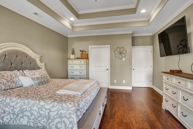 bedroom with ornamental molding, a raised ceiling, and dark hardwood / wood-style floors