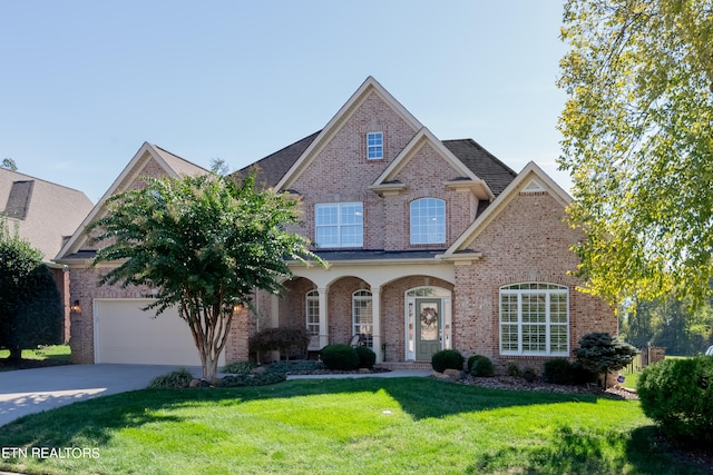 view of front of house featuring a front yard and a garage