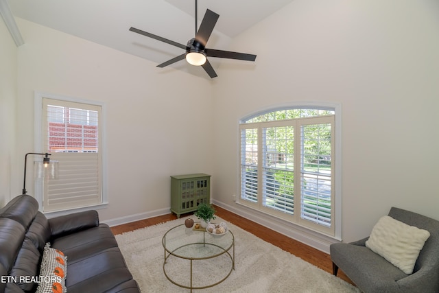 living room featuring ceiling fan, high vaulted ceiling, and wood-type flooring