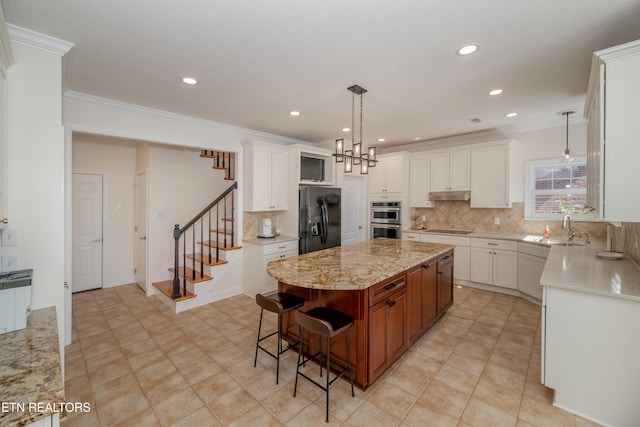 kitchen with white cabinetry, black appliances, and a center island