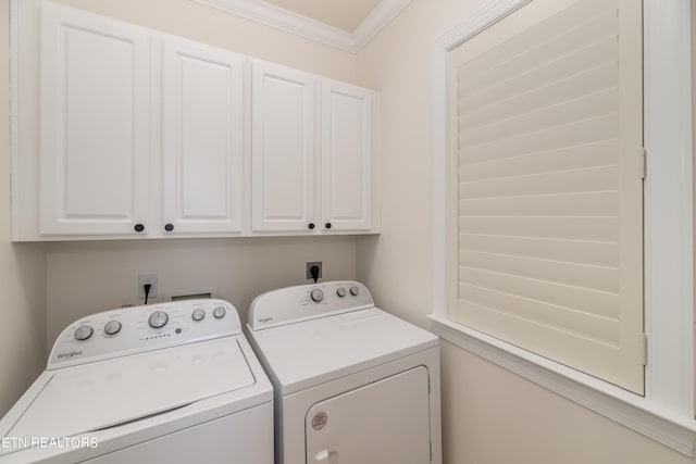 laundry room with cabinets, ornamental molding, and washer and clothes dryer