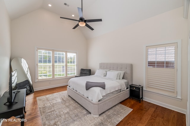 bedroom with hardwood / wood-style flooring, high vaulted ceiling, and ceiling fan