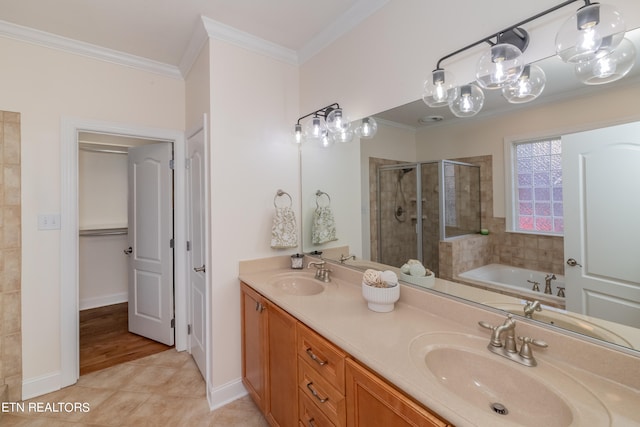 bathroom with vanity, tile patterned floors, ornamental molding, and shower with separate bathtub