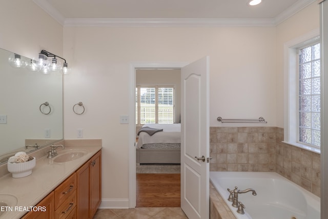 bathroom with vanity, a relaxing tiled tub, ornamental molding, and tile patterned floors