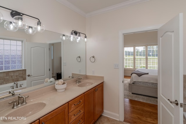 bathroom with vanity, crown molding, and hardwood / wood-style flooring