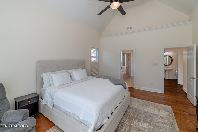 bedroom featuring connected bathroom, ceiling fan, high vaulted ceiling, and wood-type flooring