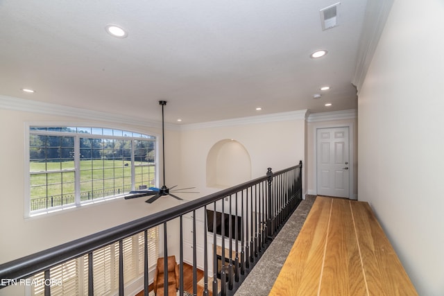 hallway featuring wood-type flooring and ornamental molding