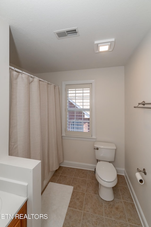 bathroom with vanity, toilet, and tile patterned floors