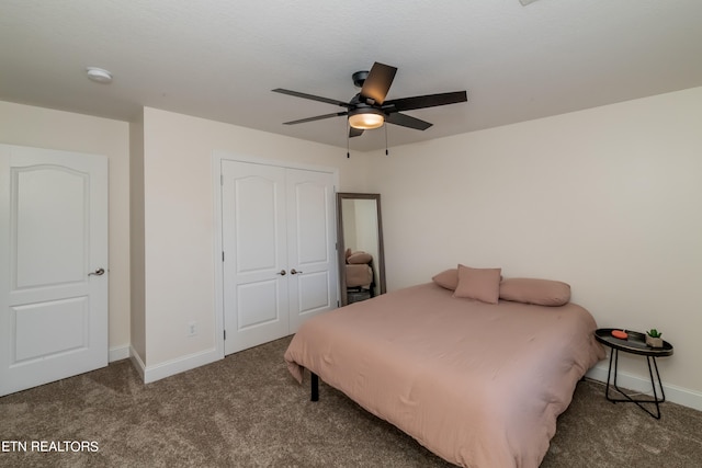 bedroom with a closet, ceiling fan, and dark colored carpet