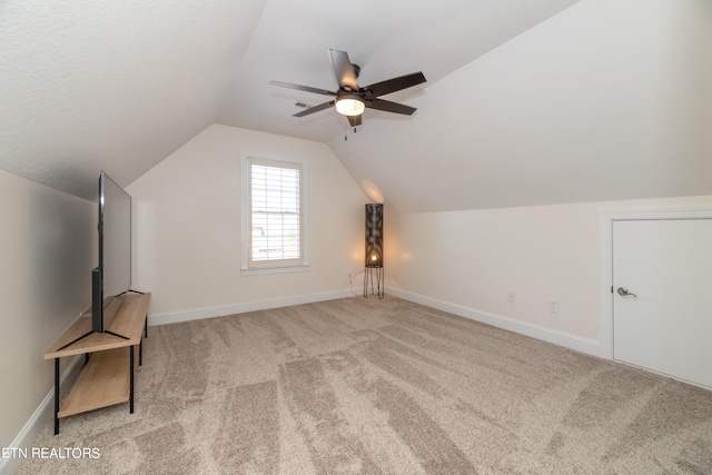 bonus room featuring light carpet, lofted ceiling, and ceiling fan