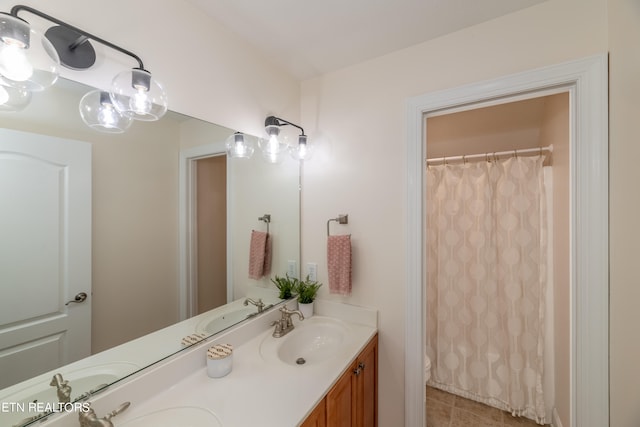 bathroom featuring vanity, toilet, a shower with curtain, and tile patterned flooring