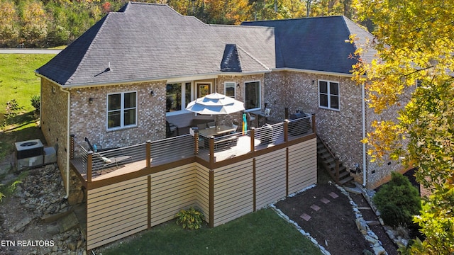 rear view of house featuring a deck and central air condition unit