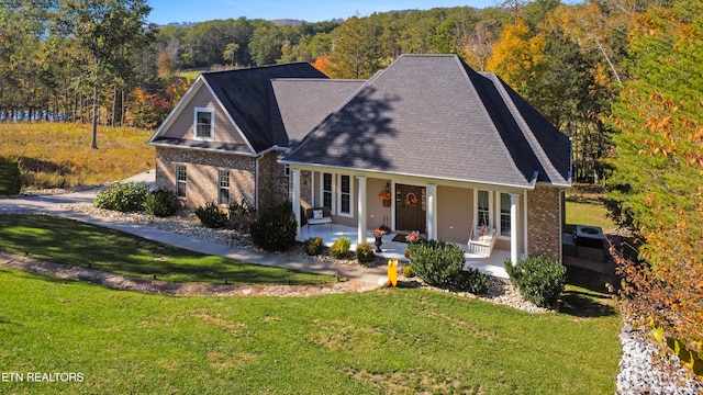 view of front of house with a front yard and a porch