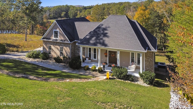 339 Eagles Rdg, Tazewell, TN 37879 - view of front of property with a porch, brick siding, a front lawn, and a wooded view