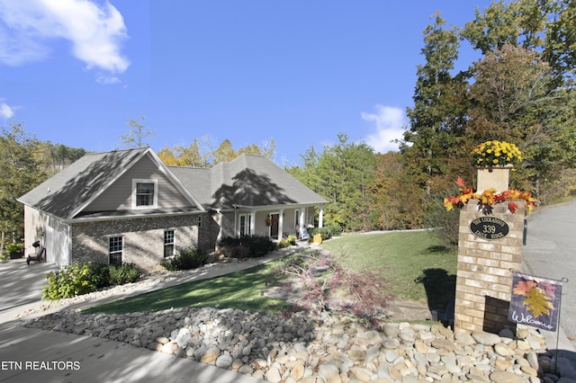 339 Eagles Rdg, Tazewell, TN 37879 - view of front facade featuring driveway, a front lawn, brick siding, covered porch, and an attached garage