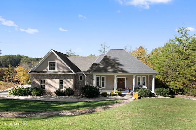 view of front facade with a front lawn and covered porch