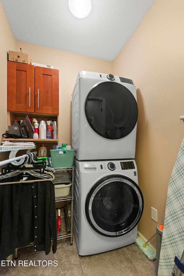 washroom with stacked washing maching and dryer