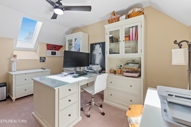 carpeted home office with lofted ceiling and ceiling fan